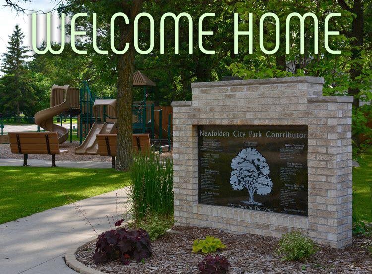 Brick sign at park entrance saying Welcome Home 